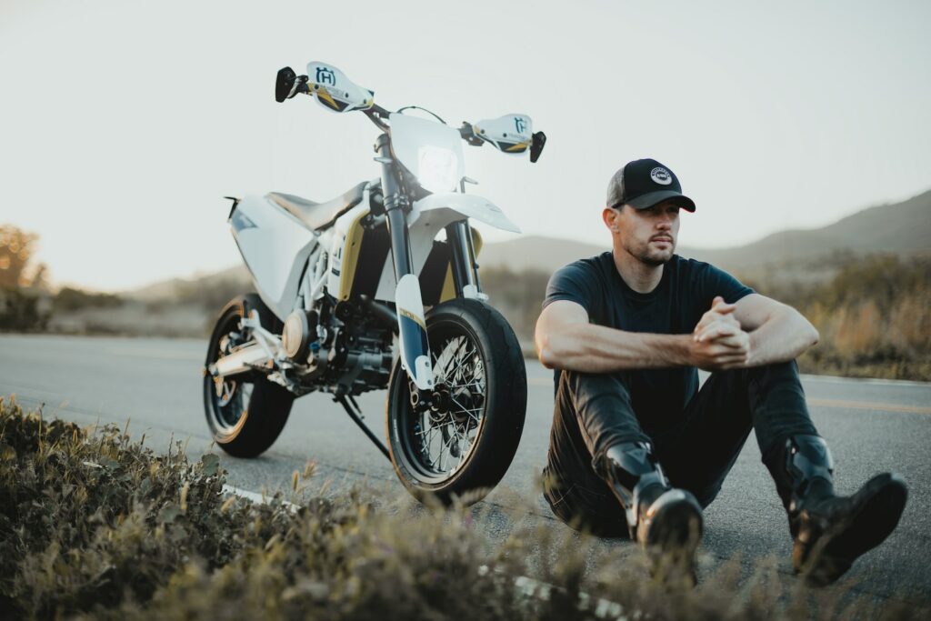 man in gray t-shirt and black pants sitting on black motorcycle