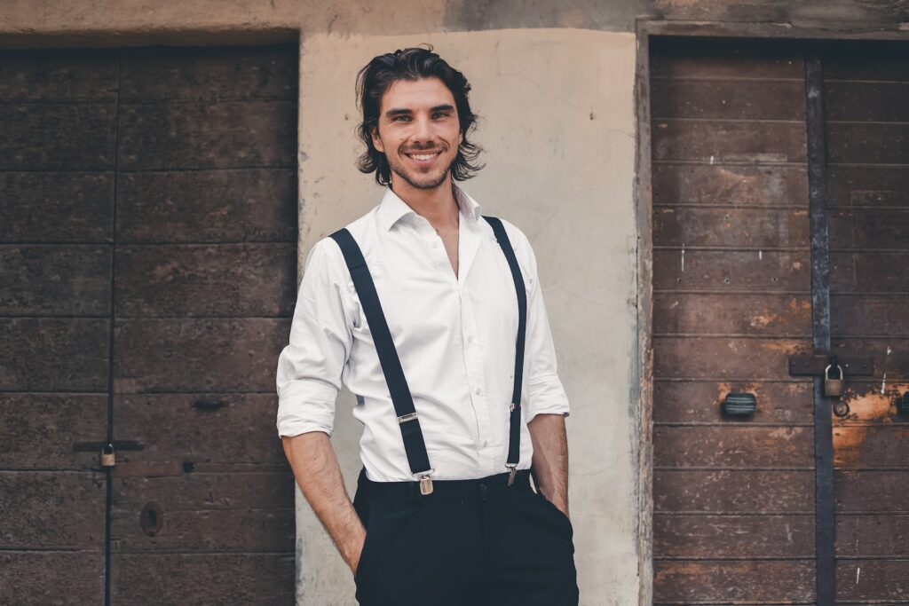 a person wearing a white shirt and suspenders